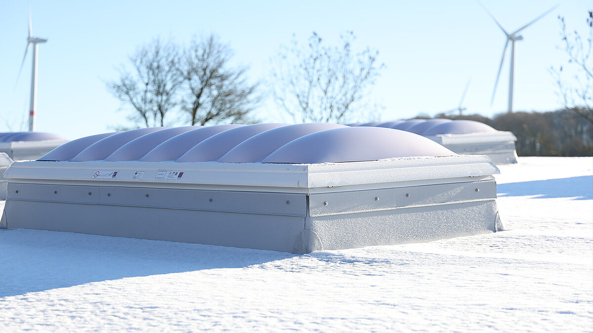 Schneebedeckte Lichtkuppel F100W auf dem Dach des Gebäudes "Ab in die Box" am Diemelsee.