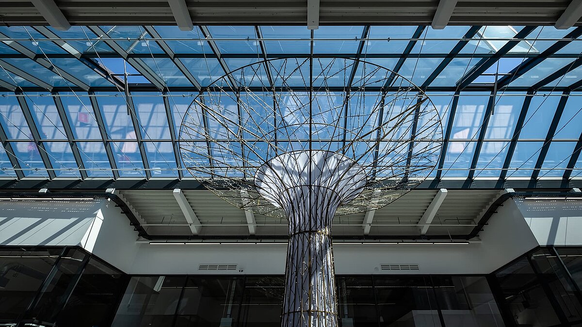 Glasdach PR60 im Outlet Center Selb mit moderner Stahlkonstruktion und einer skulpturalen Dekoration im Zentrum.