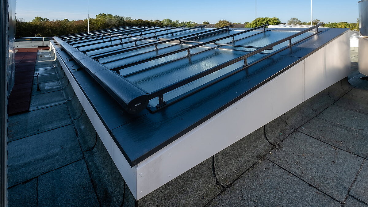 Außenansicht des modernen Glasdachs der Bertha-von-Suttner-Realschule in Köln mit Sonnenschutzsystem.